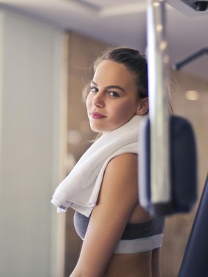 Happy young sportswoman in modern sports club