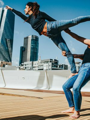 Woman in Black T-shirt and Blue Denim Jeans Jumping on White Ship